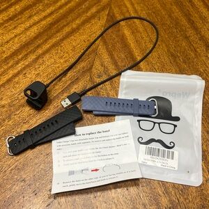 Fit Bit Charge 3. Charger and 2 new replacement bands